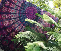 Round pink mandala tapestry used as boho tablecloth, chair throw, or beach mat