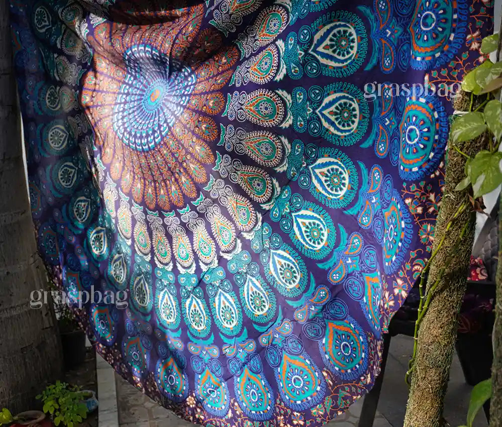 Round blue mandala tapestry used as table cover, boho chair throw, or beach sheet
